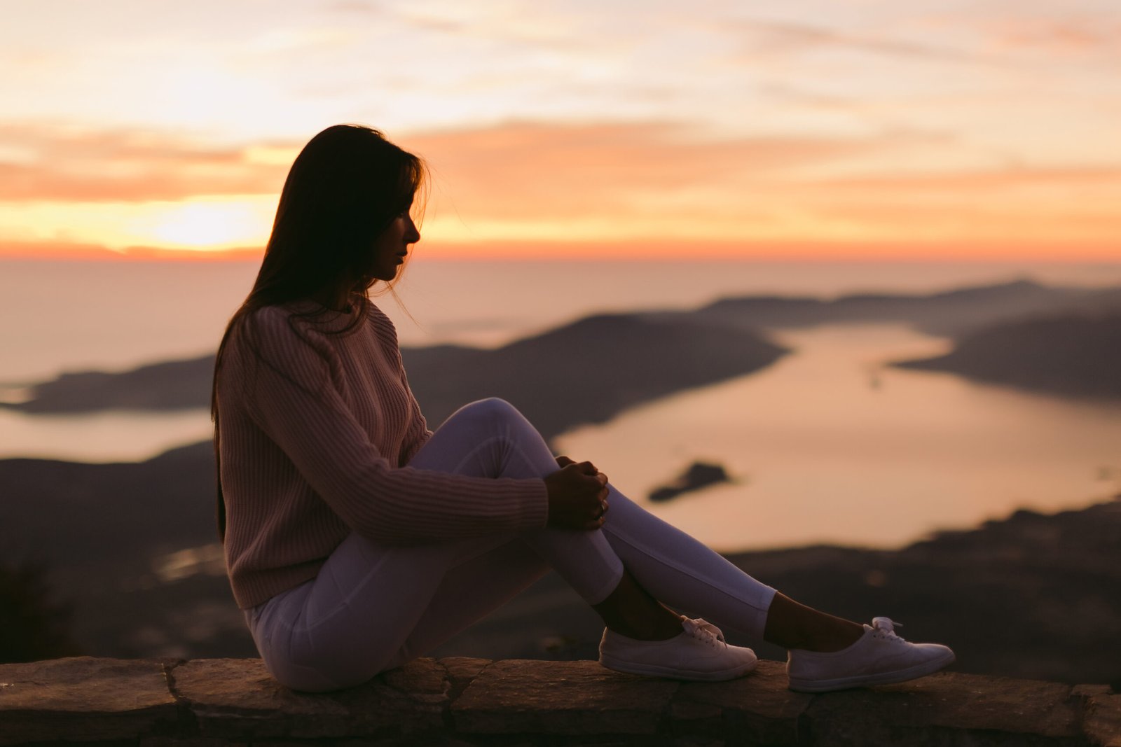 woman dreaming at sunset with mountains view woman dreaming at sunset with mountains view